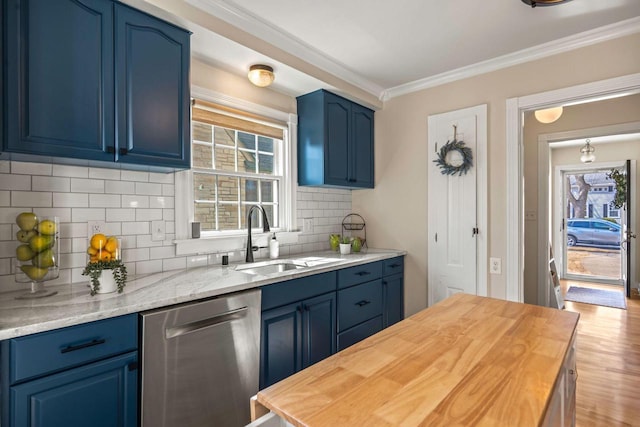 kitchen featuring blue cabinetry, crown molding, butcher block countertops, dishwasher, and a sink