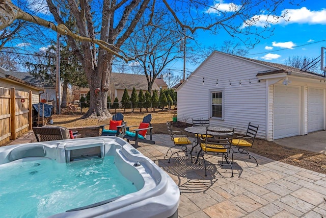 view of pool featuring a patio area, a hot tub, and fence