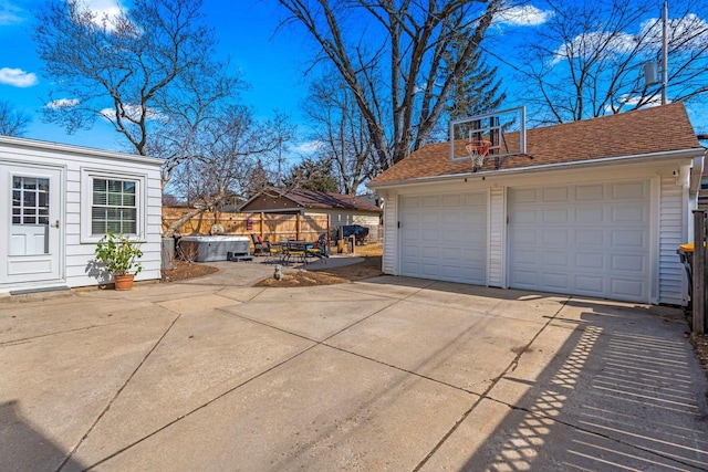 detached garage featuring fence