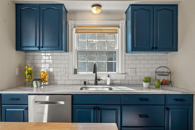 kitchen featuring stainless steel dishwasher, blue cabinets, and a sink