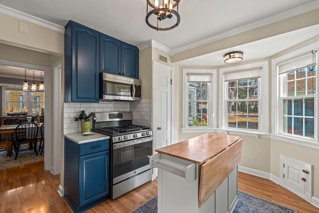 kitchen featuring blue cabinets, visible vents, a notable chandelier, and appliances with stainless steel finishes