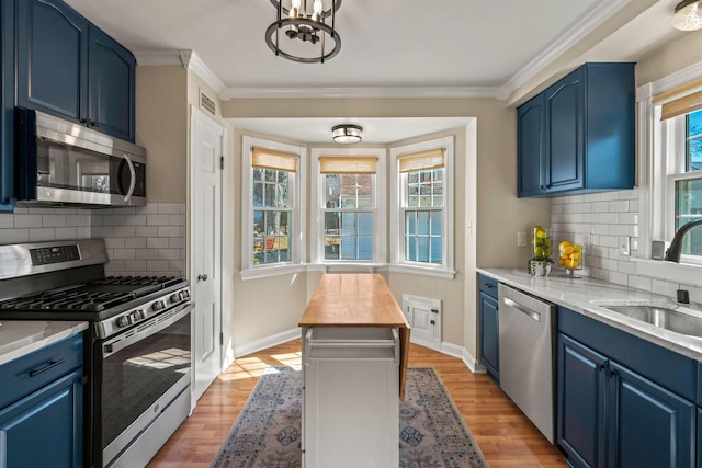 kitchen featuring blue cabinetry, appliances with stainless steel finishes, and a sink