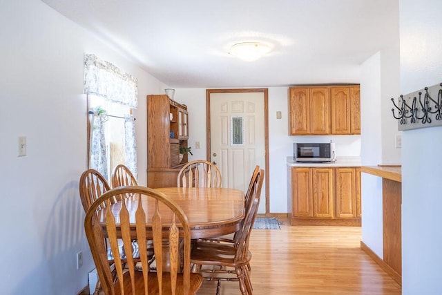 dining area featuring light wood-type flooring