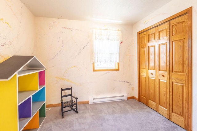 sitting room featuring baseboards, carpet floors, and a baseboard radiator