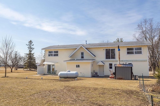 rear view of house with a patio area, central air condition unit, and a lawn