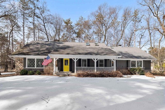 view of front of house with covered porch and a chimney