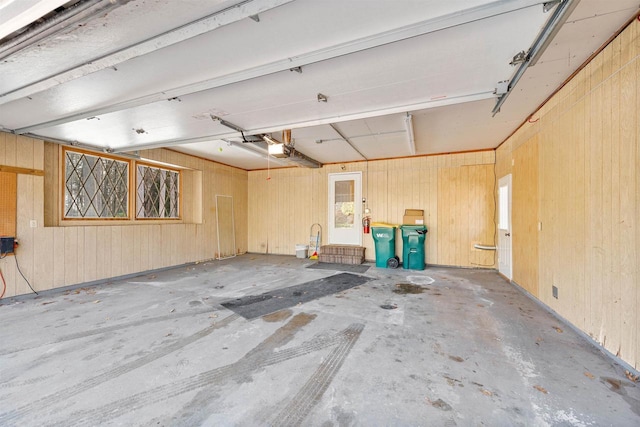 garage featuring wooden walls and a garage door opener