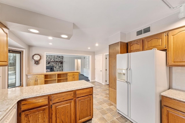 kitchen with white appliances, recessed lighting, a peninsula, and visible vents