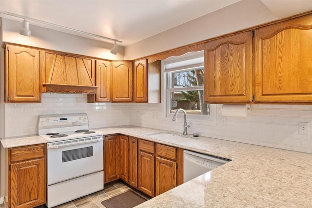 kitchen with custom range hood, a sink, light stone counters, tasteful backsplash, and white appliances