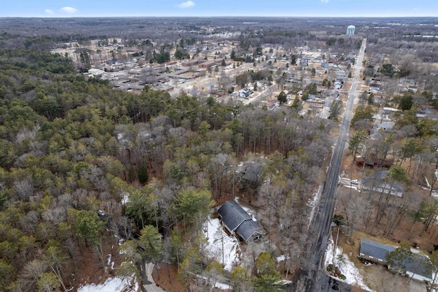 birds eye view of property with a forest view