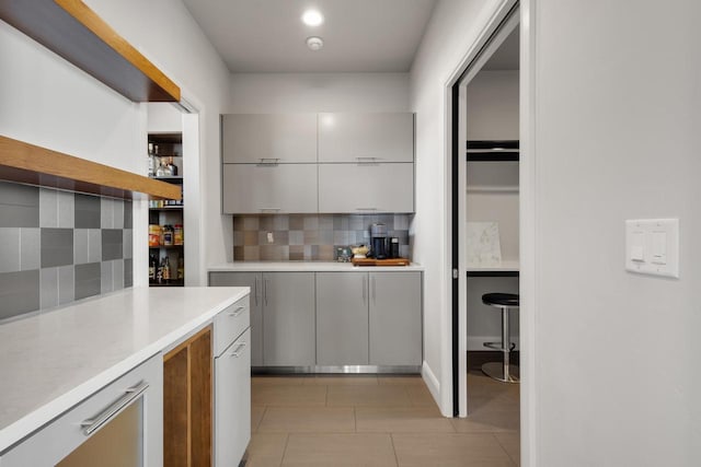 kitchen featuring backsplash, modern cabinets, and light countertops