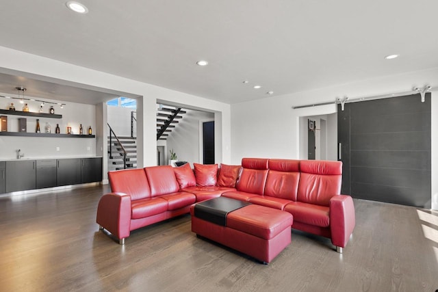 living room featuring stairs, bar area, wood finished floors, and recessed lighting