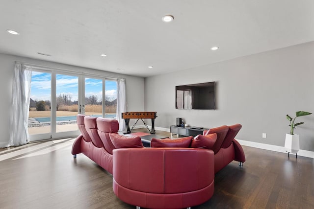 living room with recessed lighting, baseboards, and wood finished floors