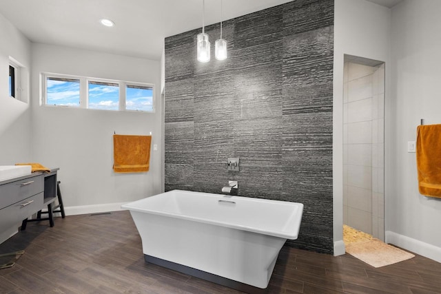 bathroom featuring a freestanding tub, a walk in shower, baseboards, and wood tiled floor