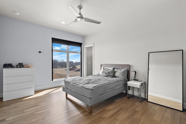 bedroom with recessed lighting, wood finished floors, baseboards, and ceiling fan