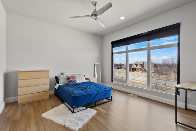 bedroom featuring wood finished floors, visible vents, baseboards, recessed lighting, and ceiling fan