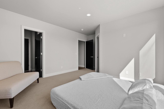 carpeted bedroom featuring recessed lighting and baseboards