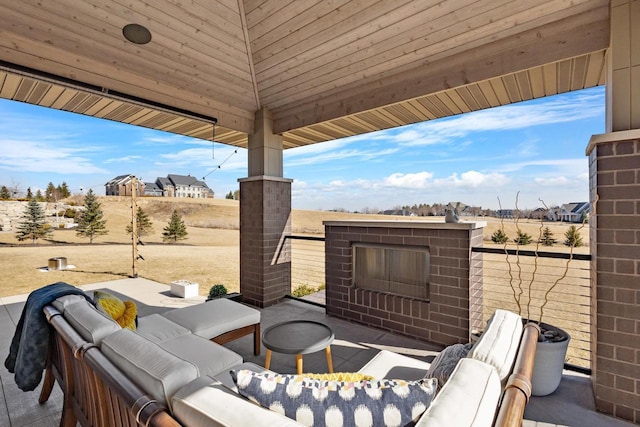 view of patio featuring an outdoor living space with a fireplace