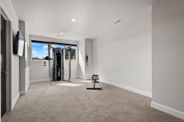 workout area featuring recessed lighting, baseboards, visible vents, and light carpet