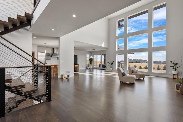 interior space featuring visible vents, stairway, wood finished floors, and baseboards