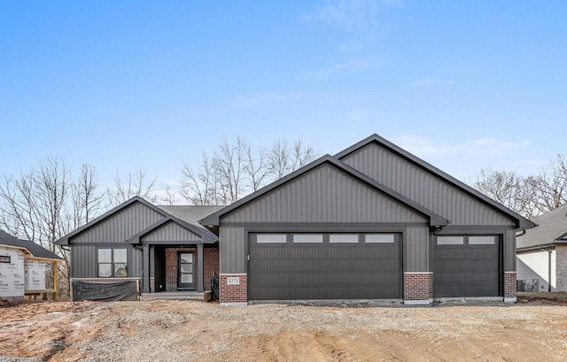 view of front of house with brick siding, driveway, and board and batten siding