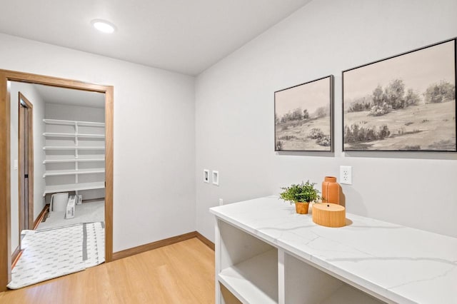 interior space featuring baseboards and light wood-style flooring