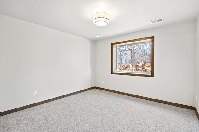 unfurnished room featuring visible vents, carpet, and baseboards