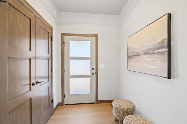 entryway with light wood-type flooring and baseboards