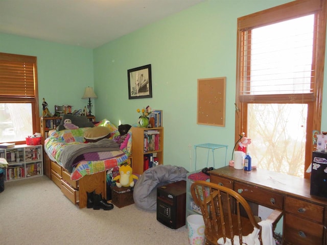 carpeted bedroom featuring multiple windows