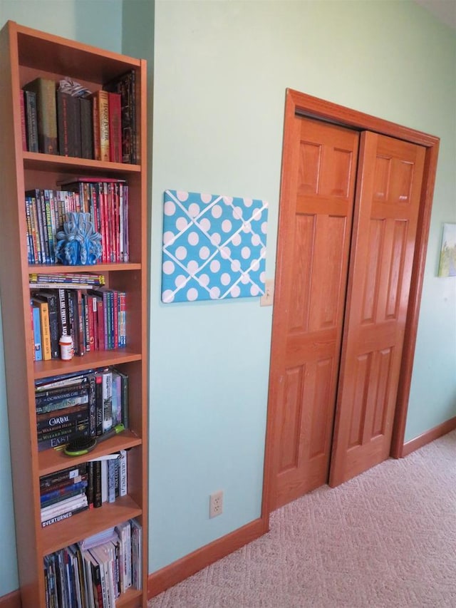 interior space featuring carpet and baseboards