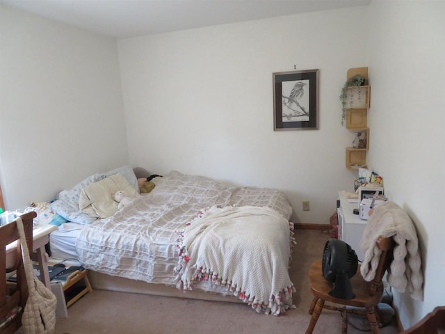 bedroom featuring baseboards and carpet floors