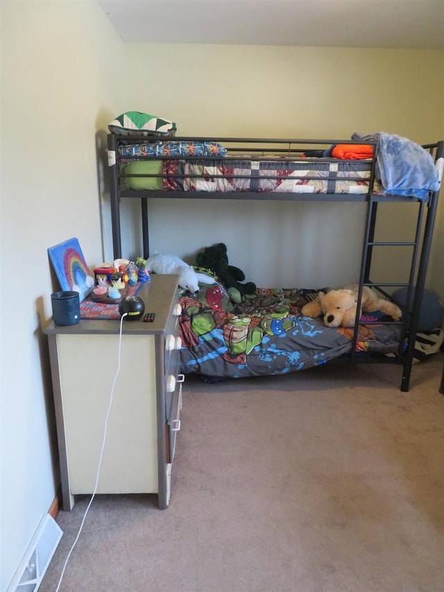 carpeted bedroom featuring visible vents