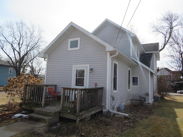 back of property featuring central AC unit and a wooden deck