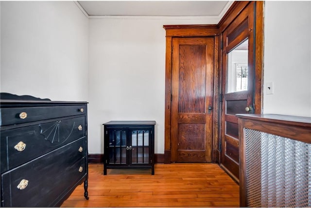 interior space with hardwood / wood-style floors and crown molding