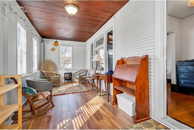 sitting room featuring wood finished floors and wooden ceiling