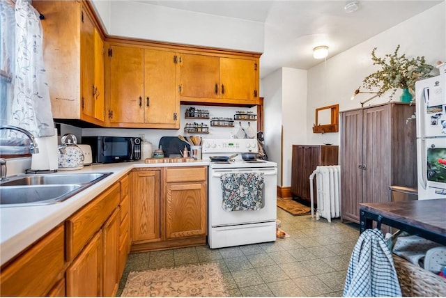 kitchen with a sink, radiator heating unit, white appliances, brown cabinetry, and light countertops