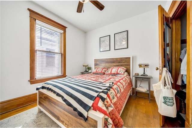 bedroom featuring hardwood / wood-style flooring, baseboards, and ceiling fan