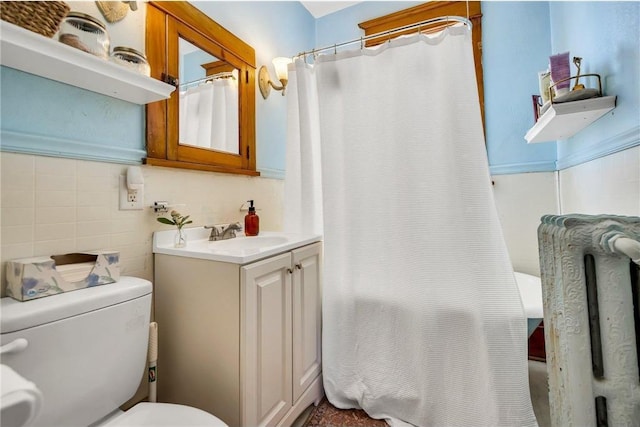 full bath featuring curtained shower, toilet, tile walls, and vanity