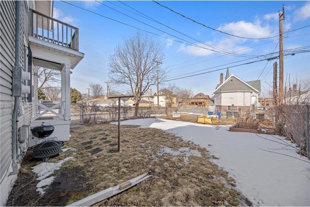 view of yard featuring a residential view, a balcony, and fence