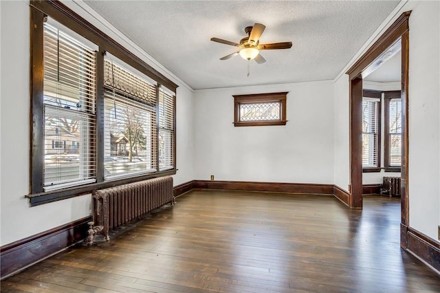 unfurnished room featuring ornamental molding, a ceiling fan, a textured ceiling, hardwood / wood-style floors, and radiator