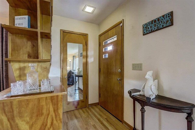 entryway featuring wood finished floors and baseboards