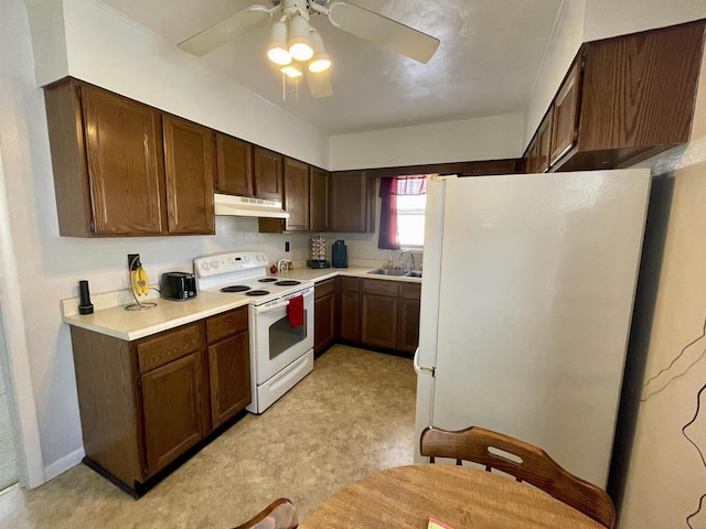 kitchen with white appliances, a ceiling fan, a sink, light countertops, and under cabinet range hood