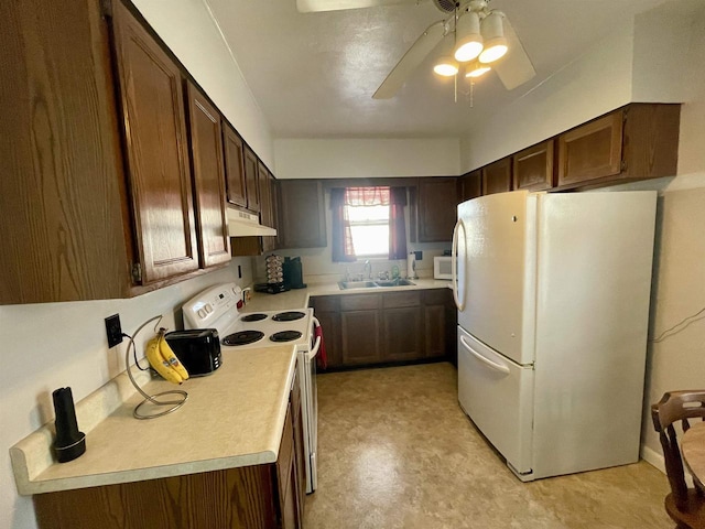 kitchen featuring under cabinet range hood, light countertops, white appliances, a ceiling fan, and a sink