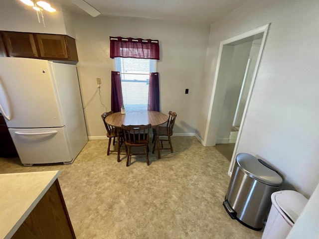 dining room featuring baseboards and a ceiling fan