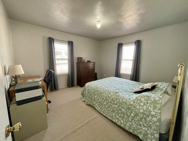 bedroom featuring light carpet and multiple windows