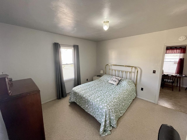 bedroom featuring baseboards and carpet