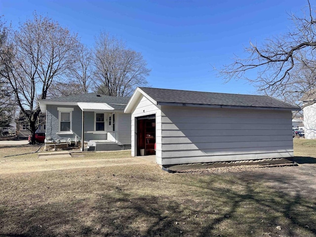 view of front of property featuring an outdoor structure and an attached garage