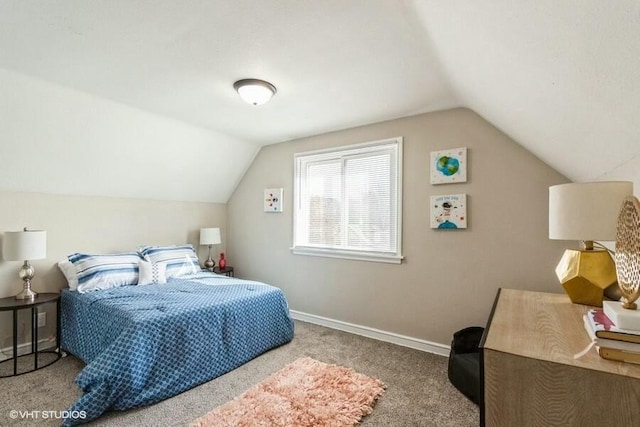 bedroom featuring vaulted ceiling, baseboards, and carpet floors