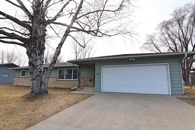 ranch-style home with brick siding, driveway, and a garage