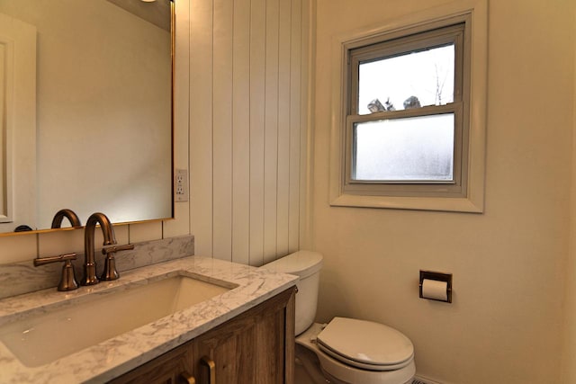 half bathroom with toilet and vanity